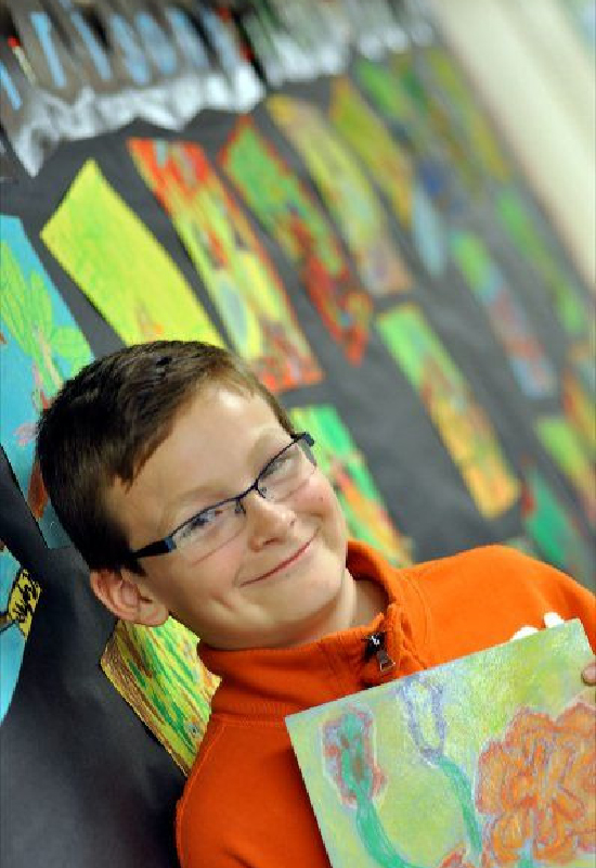 Student holding artwork